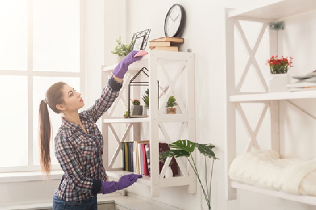 A woman cleans her living room